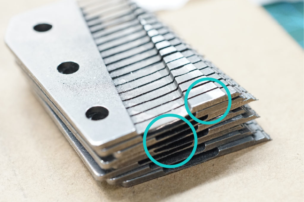 The above images show two parts that can be modified to make the lower notes: (1) adding lead weight on the “front end” of the music box comb, (2) thinning the “root part” of the music box comb.
